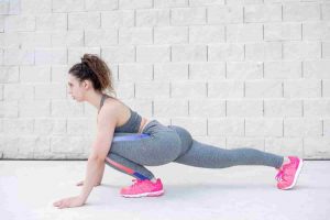 pretty sporty woman stretching legs near brick wall Preventing Injuries Preventing Injuries,injury rehabilitation,wellness services,chiropractic care Wesley Chapel Spine and Sport Medicine