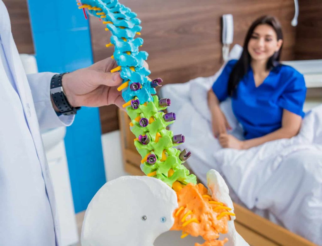 orthopedist showing spine model patient hospital 1 Chiropractic Chiropractic,Laser therapy Wesley Chapel Spine and Sport Medicine
