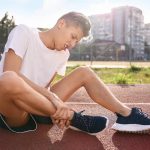 sports injury man suffering from leg pain stadium 1 Early Car Accident Treatment Latest vein treatments 2025 Wesley Chapel Spine and Sport Medicine