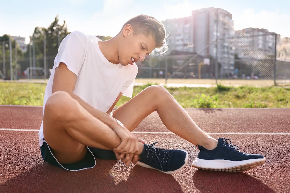 sports injury man suffering from leg pain stadium 1 Our blog Our blog,Chiropractic Care FL,Spine Health Florida,Pain Relief,Wesley Chapel Clinic Wesley Chapel Spine and Sport Medicine