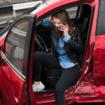 young pretty scared woman car calls rescue service Early Car Accident Treatment Latest vein treatments 2025 Wesley Chapel Spine and Sport Medicine
