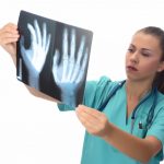 doctor radiologist holds x ray patient 1 Digital Motion X-Ray Digital Motion X-Ray Wesley Chapel Spine and Sport Medicine