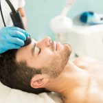 profile view good looking young man getting rf facial treatment health spa 1 Cryotherapy for Pain Relief Cryotherapy for Pain Relief Wesley Chapel Spine and Sport Medicine