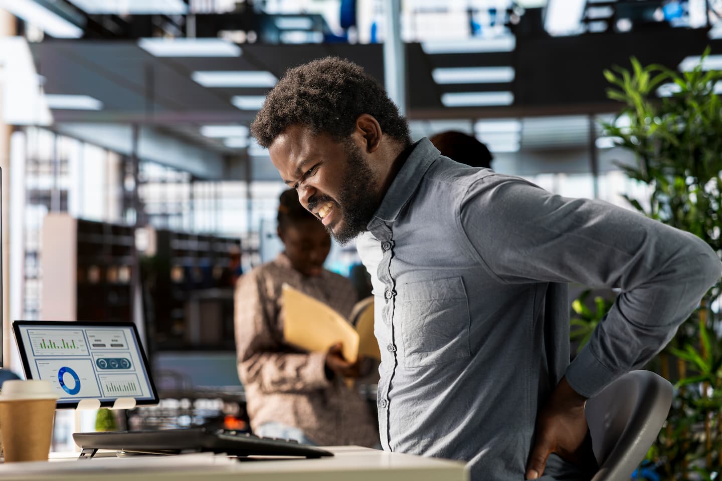 african american business analyst deals with back pain muscle cramps 1