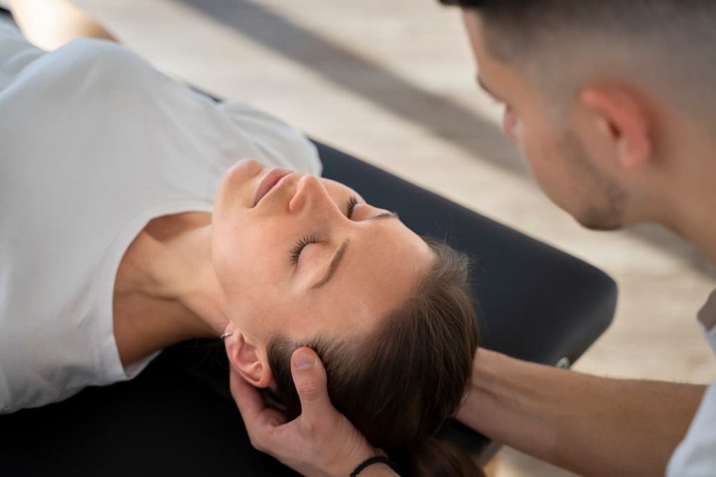 close up therapist holding patient s head 1 6 1 our team our team,wesley chapel doctors,unnecessary risk,highly effective,pain medications Wesley Chapel Spine and Sport Medicine