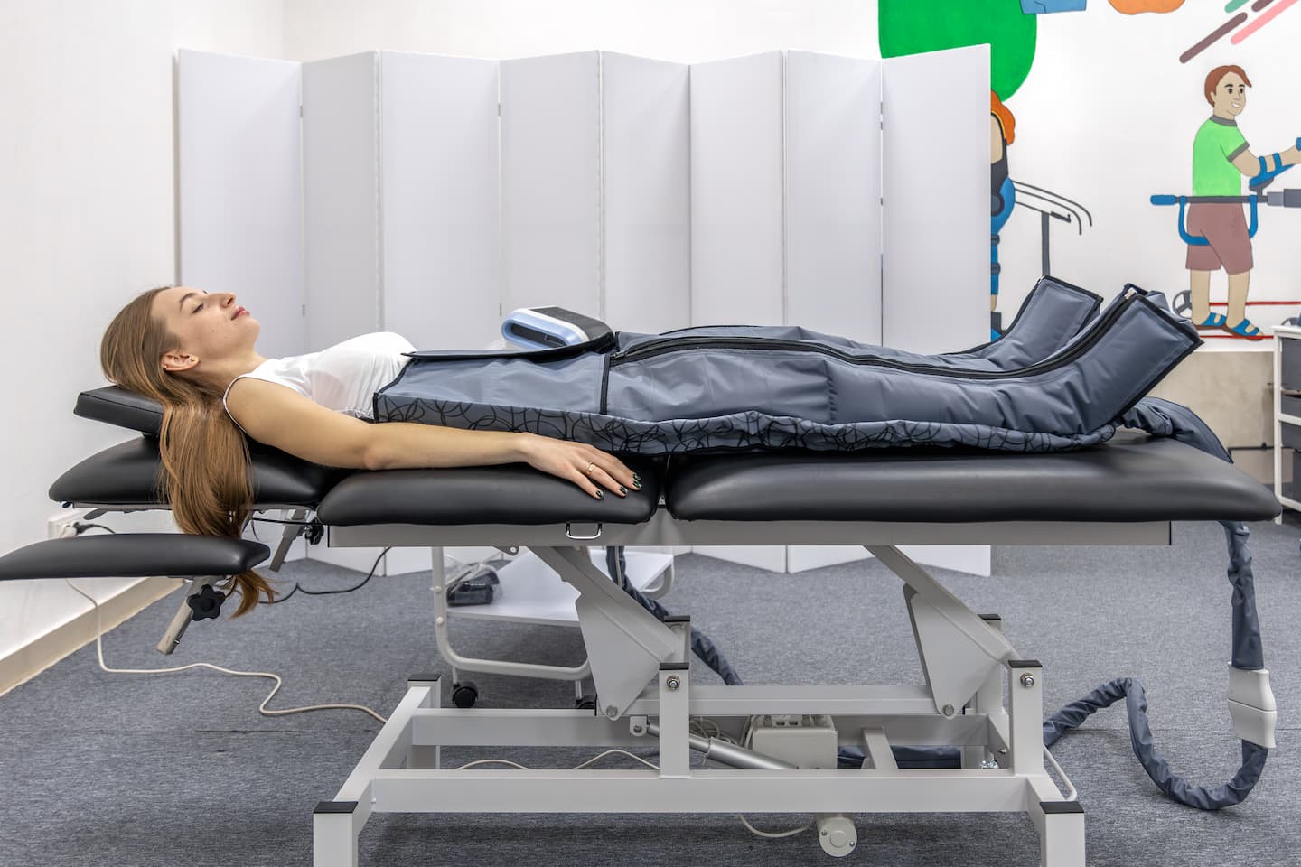 woman receives pressotherapy rehabilitation center wellness recovery 1 4 VAX-D Spinal Decompression VAX-D Spinal Decompression, Non-Surgical Spinal Decompression, Back Pain Relief Treatment, VAX-D Therapy Near Me, Avoid Back Surgery Wesley Chapel Spine and Sport Medicine